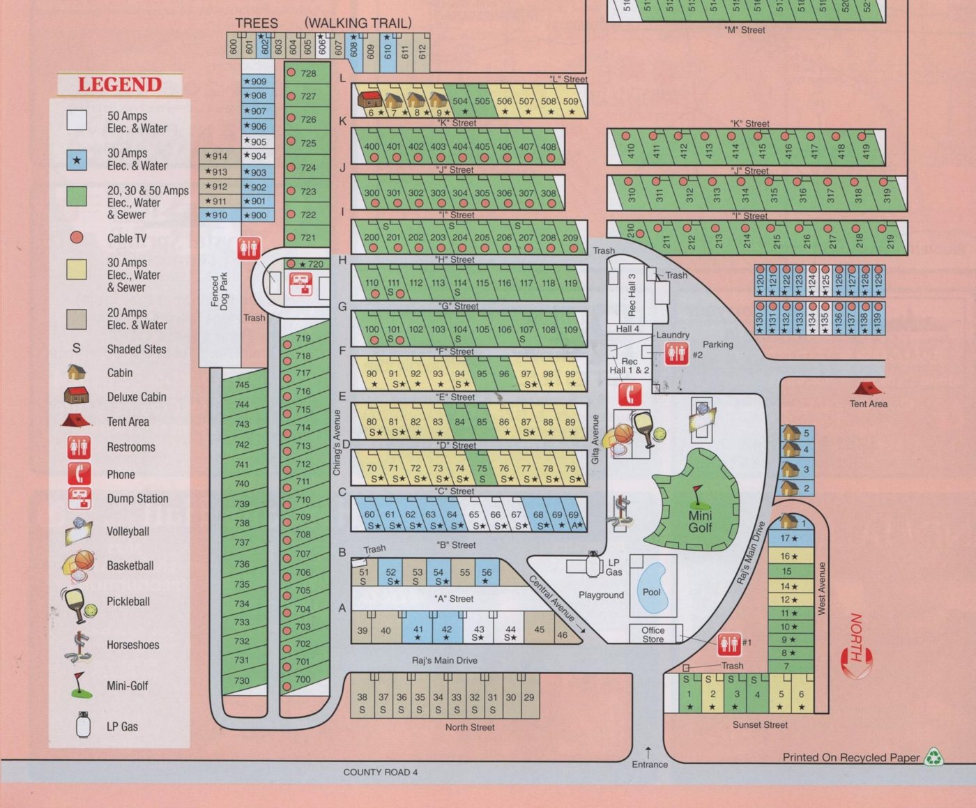Campground map showing numbered RV sites along lettered streets, cabins, restrooms, laundry, recreation halls, the pool, mini golf, playground, fenced dog park, dump station, LP gas, and the entrance on County Road 4.
